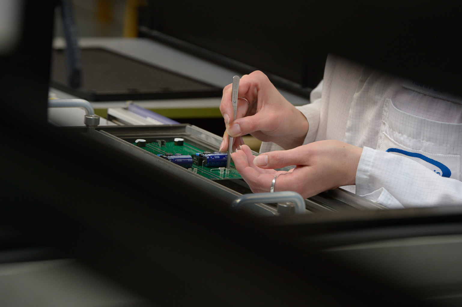 A printed circuit board is assembled by hand with THT components
